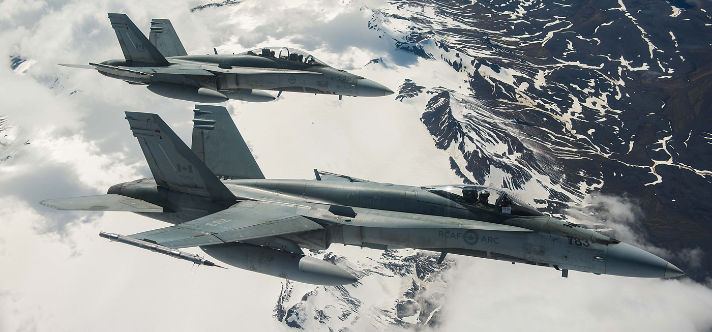 Two RCAF CF-188 Hornet fighters from 433 Tactical Fighter Squadron fly over Iceland during an Operation Reassurance surveillance mission in 2017. Cpl Gary Calve Photo
