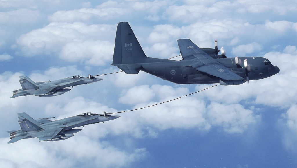Two CF-188 Hornets perform an air refuel with a CC-130T Hercules on a flight from Canada to Iceland in April 2011 to join Task Force Iceland in support of Operation Ignition. Sgt Dwayne Janes Photo