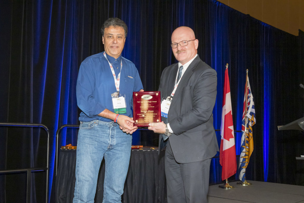 Danny Sitnam, left, receives the 2019 Agar-Stringer Award from HAC President Fred Jones. Helijet Photo