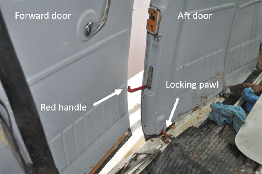Rear cargo door and latches. The red one in the end of the door will not clear the partially opened front door. TSB Photo