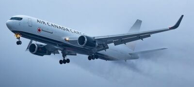 Air Canada Cargo streaks across grey skies. Photo courtesy of @aerofoil_imagery
